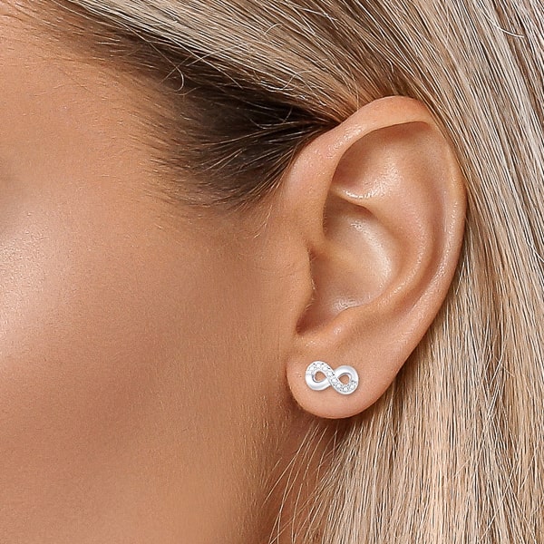Woman wearing silver infinity stud earrings
