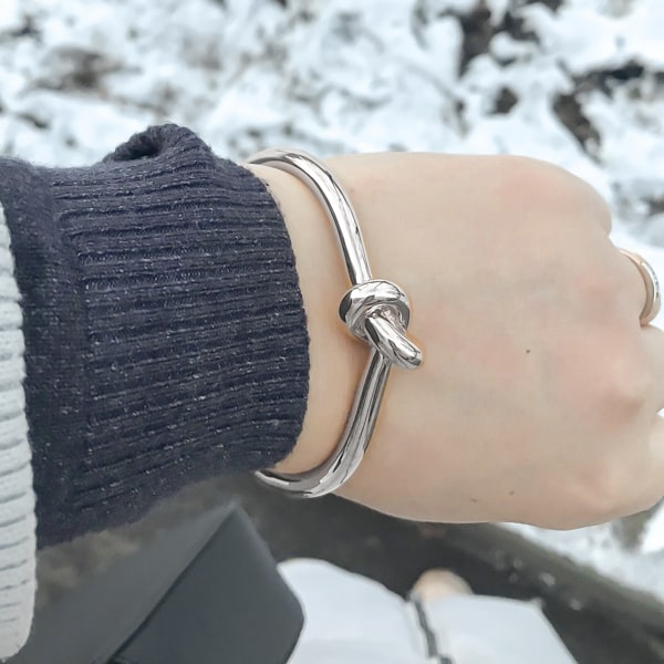Silver knot cuff bracelet displayed on woman's wrist