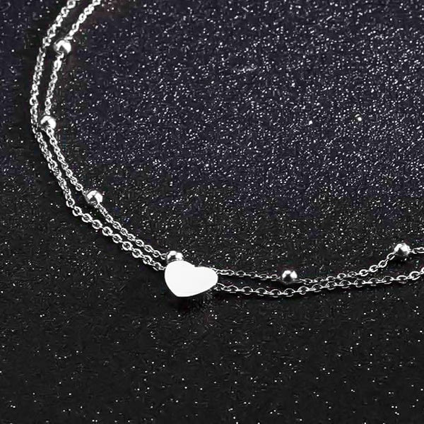 Silver layered beads and heart ankle bracelet close details