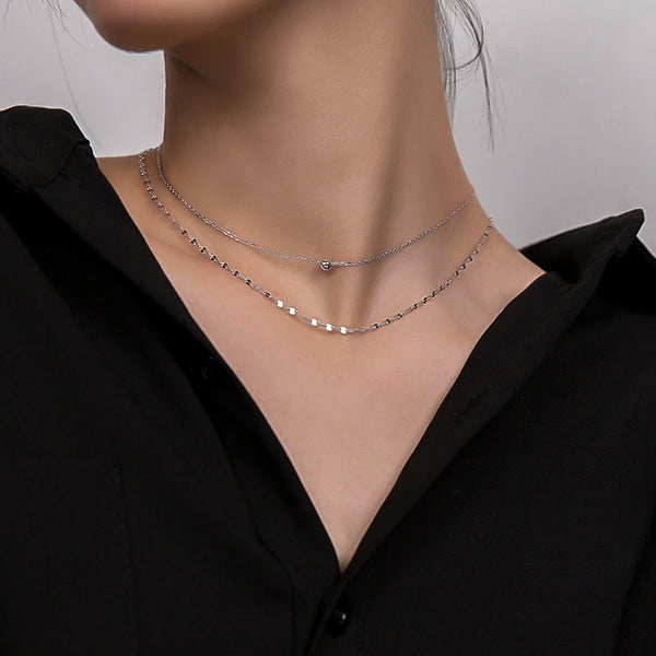 Woman wearing a silver layered choker necklace
