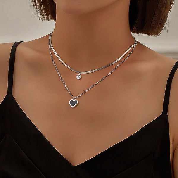 Woman wearing a silver layered heart crystal pendant necklace