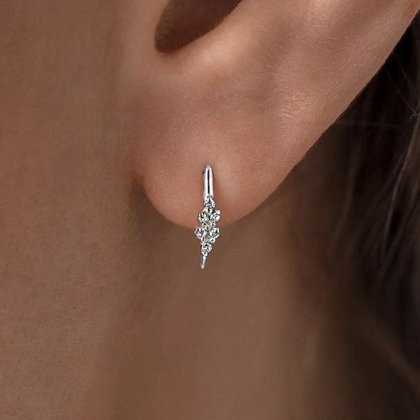 Woman wearing silver mini huggie threader earrings