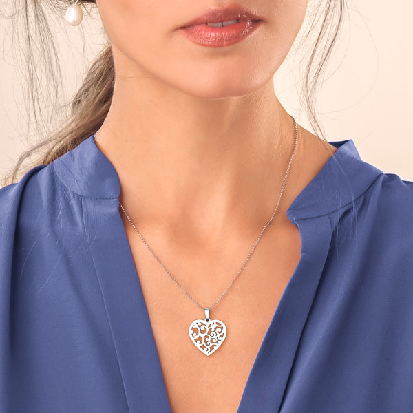 Woman wearing silver mycelium heart pendant necklace