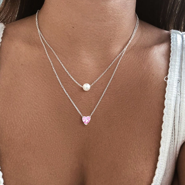 Woman wearing a silver pink crystal heart necklace