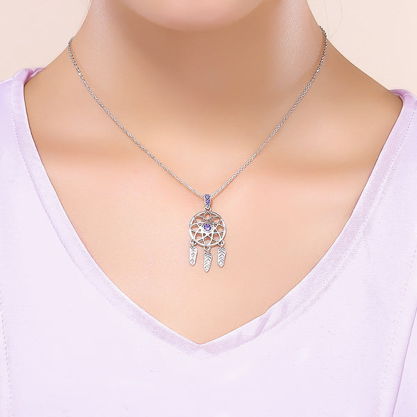 Woman wearing a silver & purple dreamcatcher pendant necklace