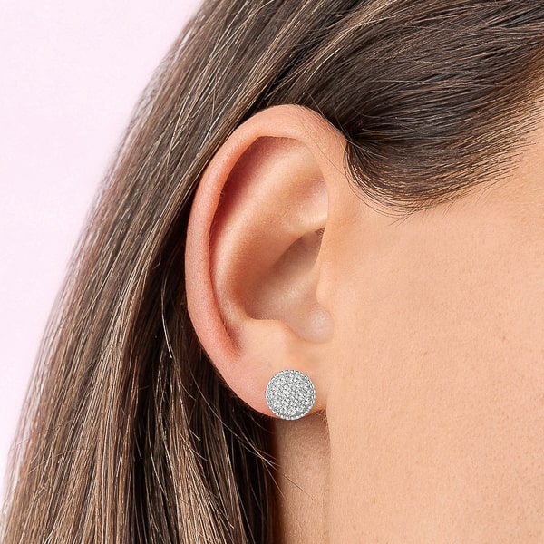 Woman wearing silver round crystal pavé stud earrings