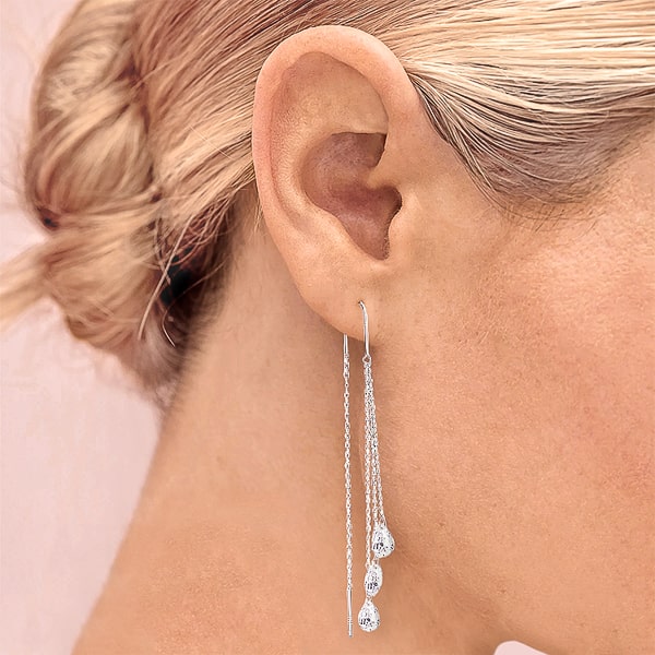 Woman wearing silver teardrop crystal threader earrings