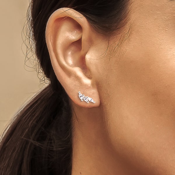 Woman wearing silver triple marquise stud earrings