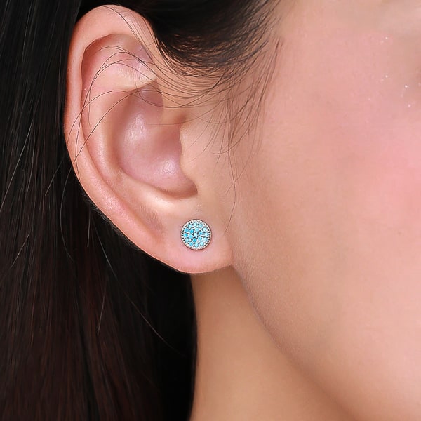 Woman wearing silver turquoise stud earrings
