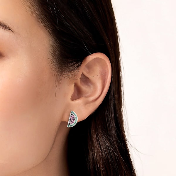 Woman wearing silver watermelon stud earrings