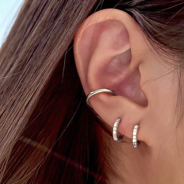 Silver white crystal huggie earrings on woman