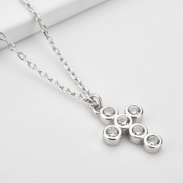 Silver rounded cross necklace with white crystals details