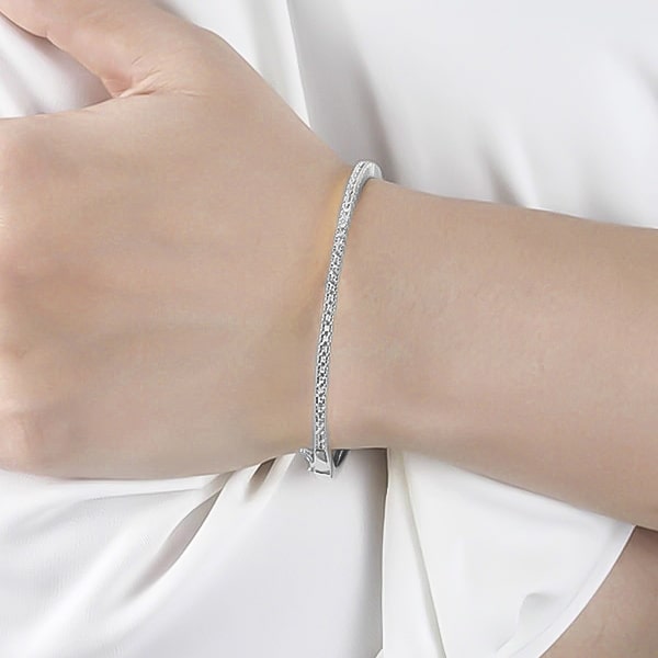Silver zirconia bangle bracelet on a woman's wrist