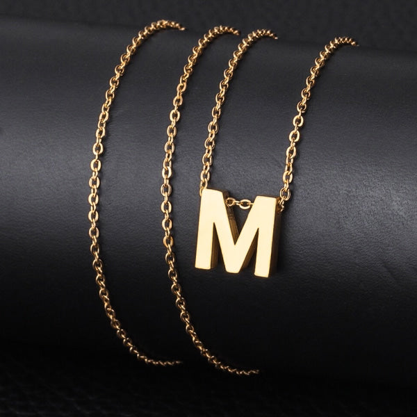 Simple gold initial necklace with polished letter charm