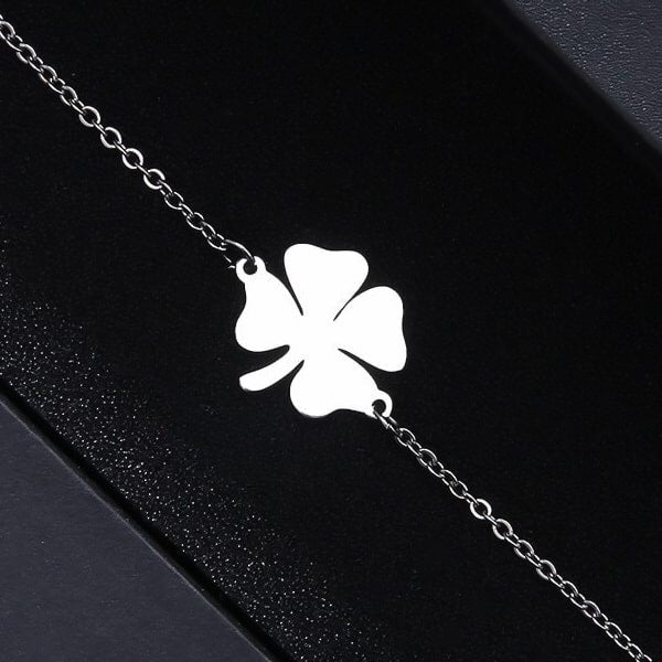Simple silver lucky bracelet with a four-leaf clover charm