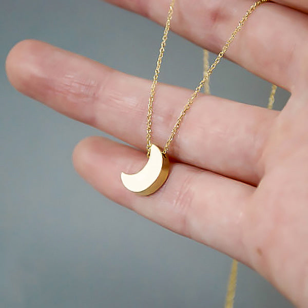 Small gold moon necklace display