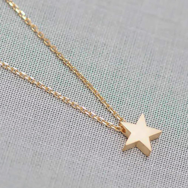 Small gold star necklace display