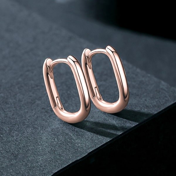 Details of the small rose gold oval hoop earrings