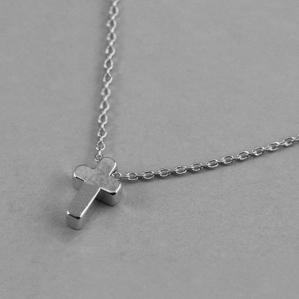 Small silver cross necklace display
