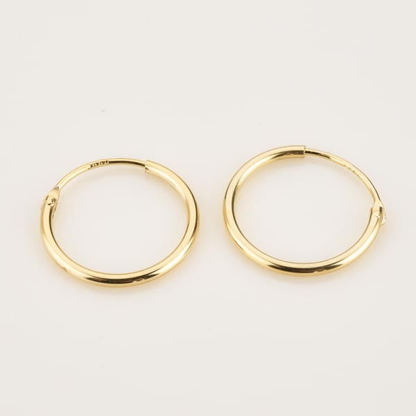 Small thin gold hoop earrings detail