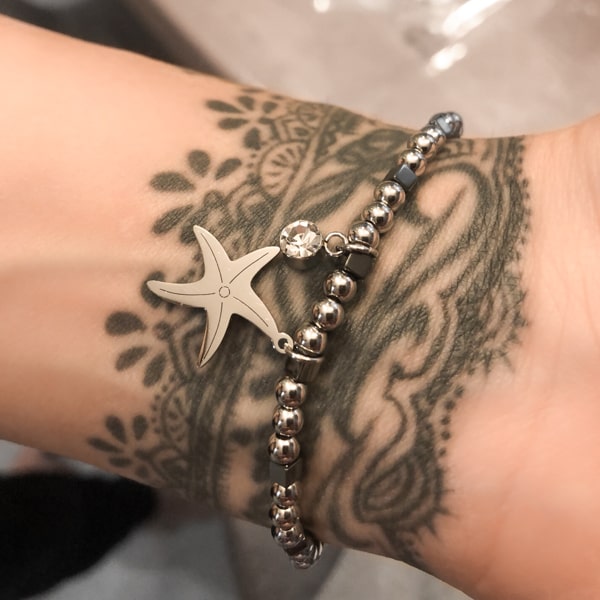 Woman wearing a starfish bracelet on her wrist