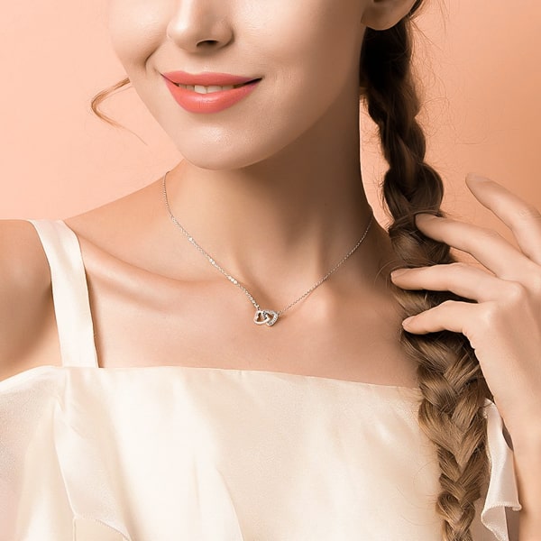Woman wearing a sterling silver double heart necklace