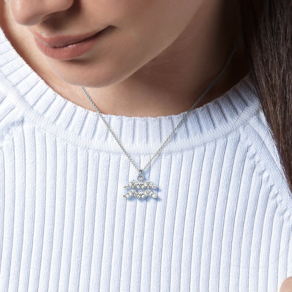 Woman wearing a sterling silver Aquarius necklace