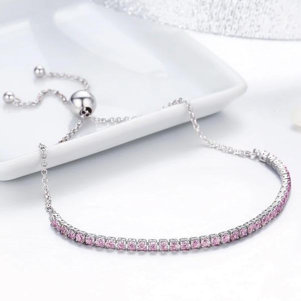 Sterling silver tennis bracelet with pink crystals and an adjustable bolo closure