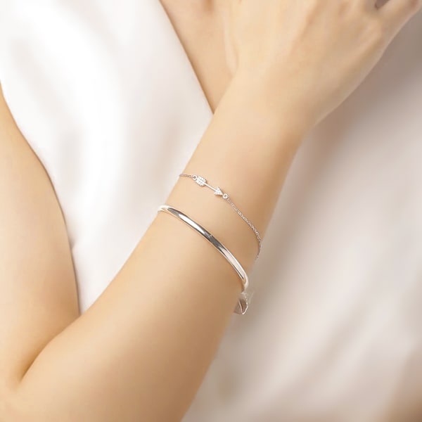 Sterling silver arrow bracelet on a woman's wrist