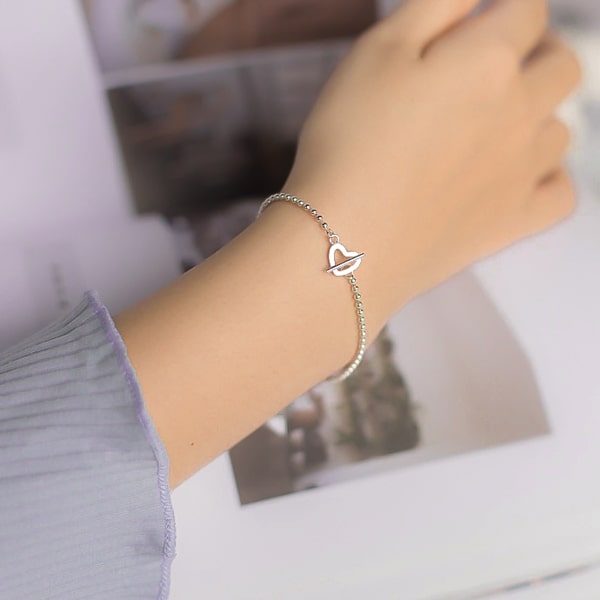 Sterling silver beaded heart bracelet on a woman's wrist