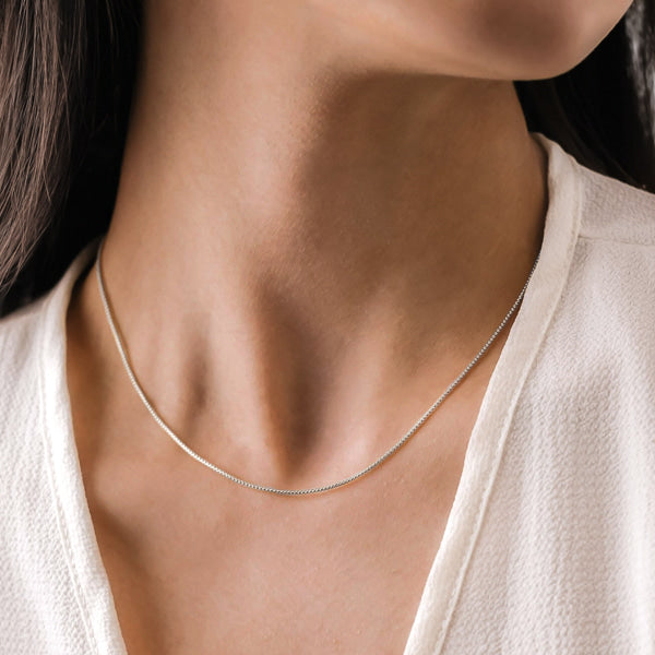 Woman wearing sterling silver box chain necklace