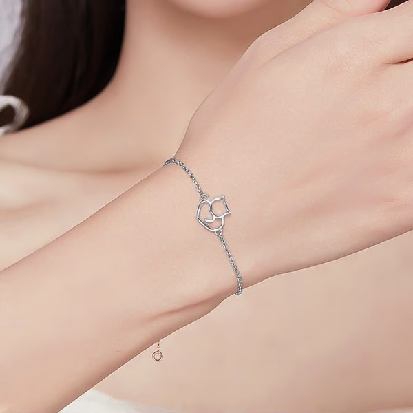 Sterling silver cat bracelet on a woman's wrist