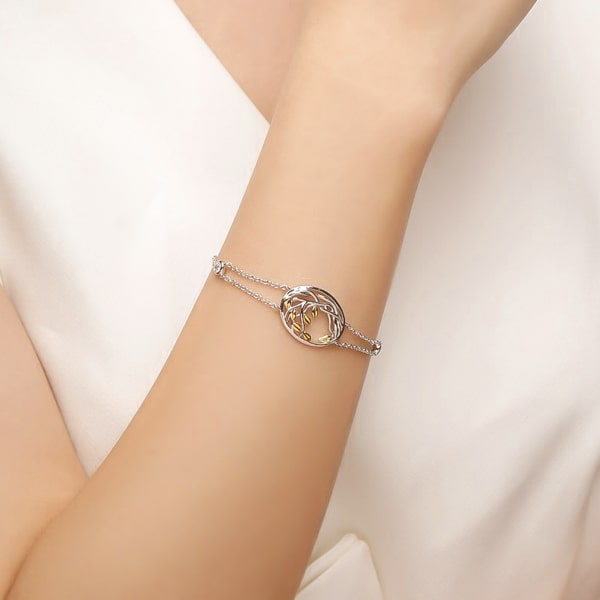 Sterling silver designer leaf bracelet on a woman's wrist