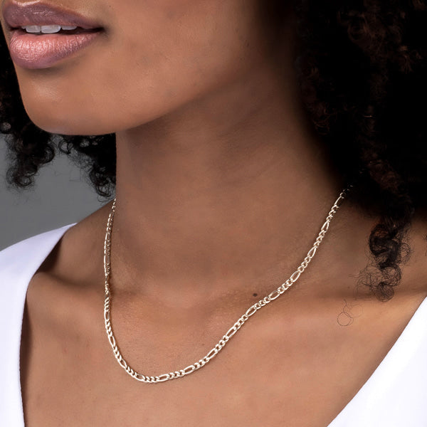 Woman wearing sterling silver figaro chain necklace