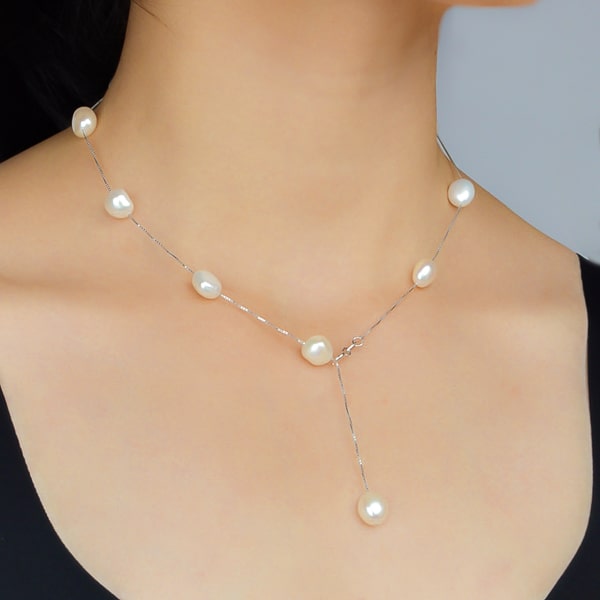 Woman wearing a silver freshwater pearl drop necklace