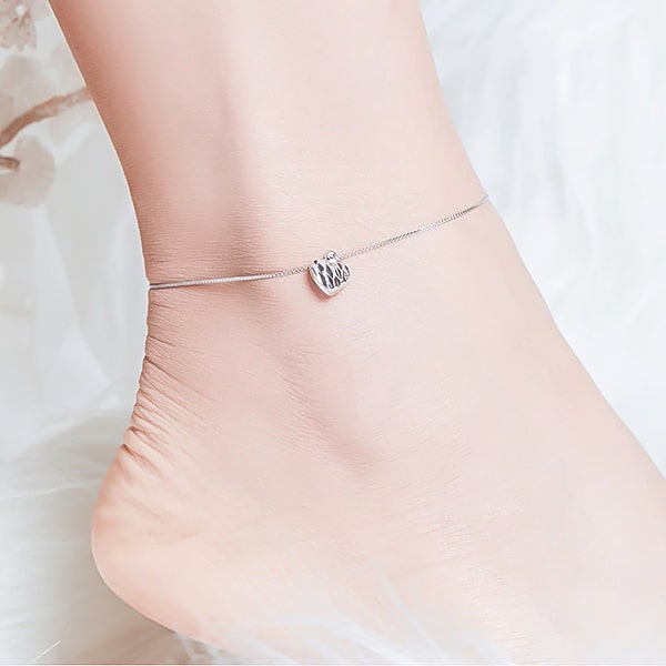 Silver heart anklet on a womans ankle