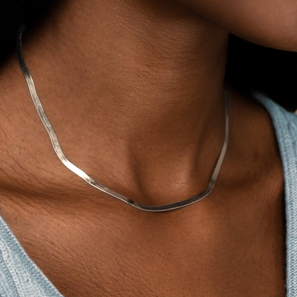 Woman wearing sterling silver herringbone chain necklace