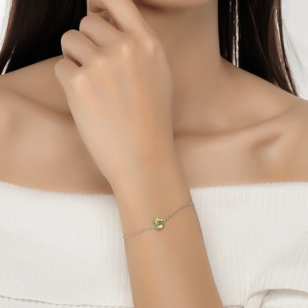Sterling silver round-cut peridot bracelet on a woman's wrist