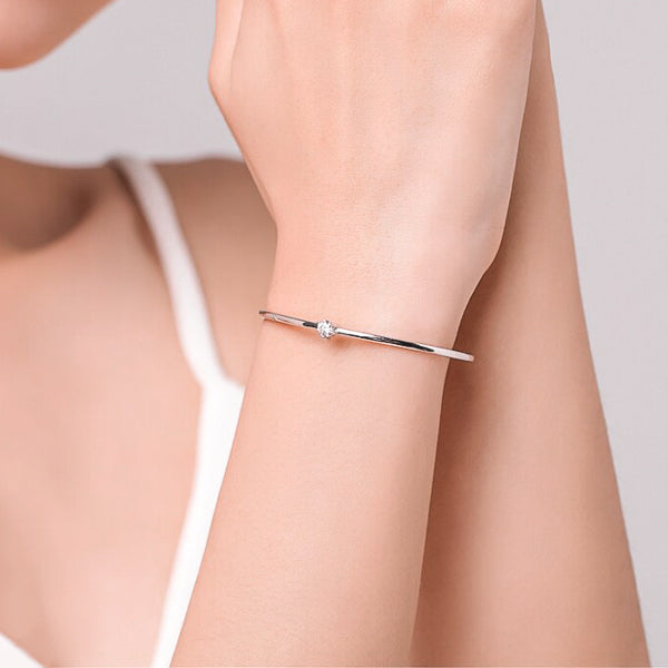 Sterling silver solitaire cuff bracelet on woman's wrist