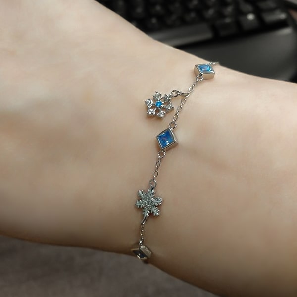 Sterling silver snowflake bracelet on a woman's wrist