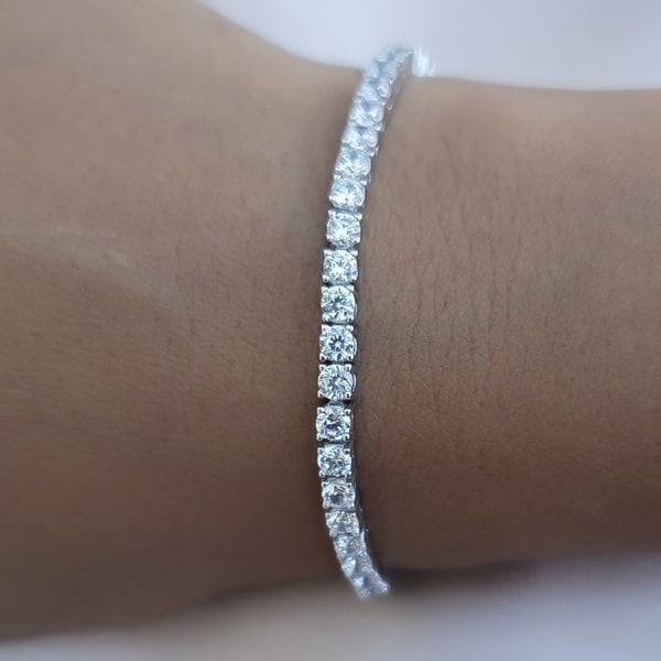 Sterling silver tennis bracelet close up on woman's wrist