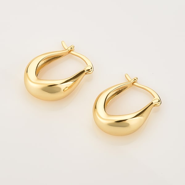 Thick gold teardrop hoop earrings detail