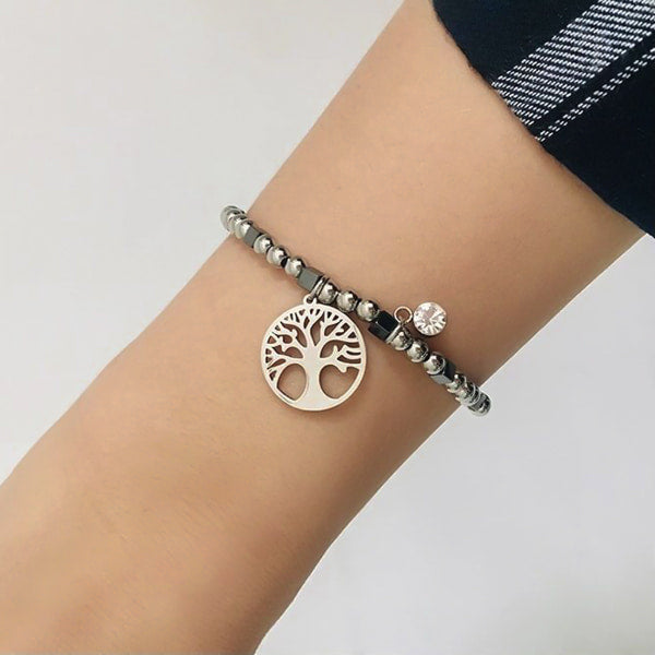 Woman wearing a tree of life bracelet on her wrist
