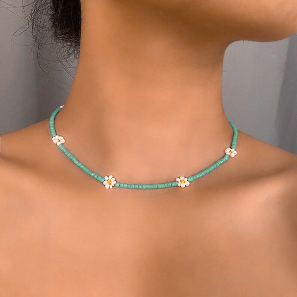 Woman wearing a turquoise beaded daisy flower choker necklace