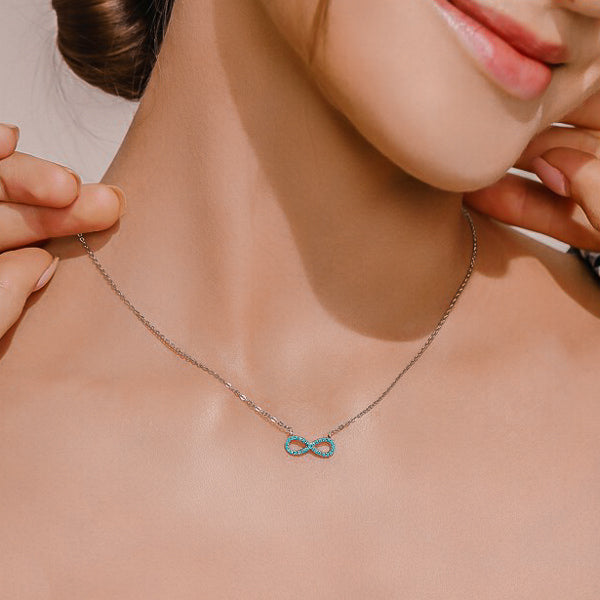 Turquoise infinity necklace on a woman