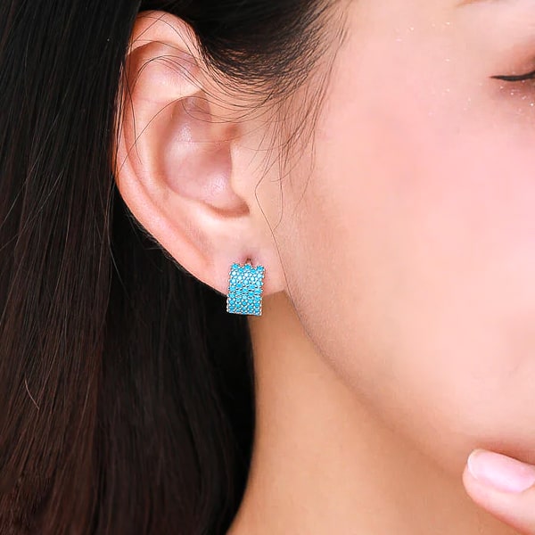 Woman wearing turquoise hoop earrings