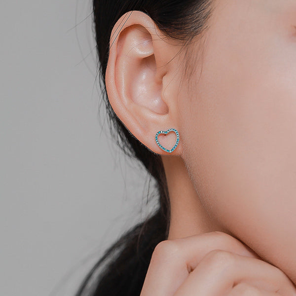Turquoise open heart stud earrings on model