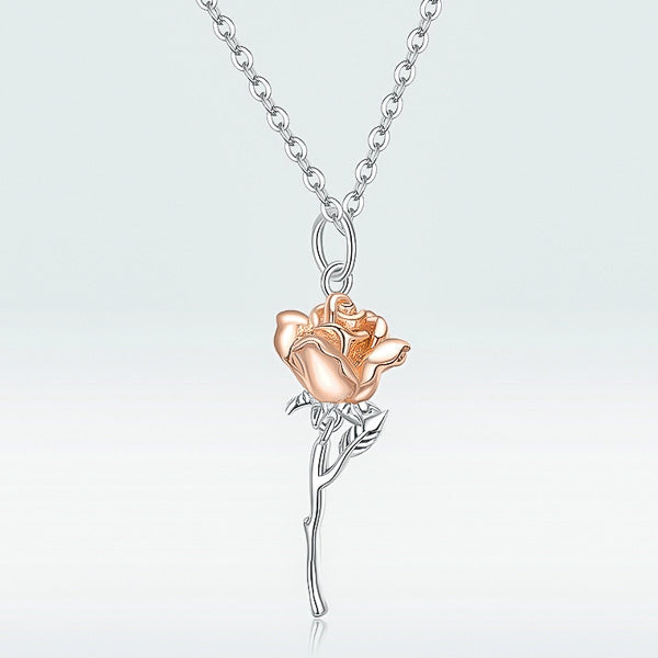 Details of the two-tone rose flower pendant with rose gold leaves on a silver necklace