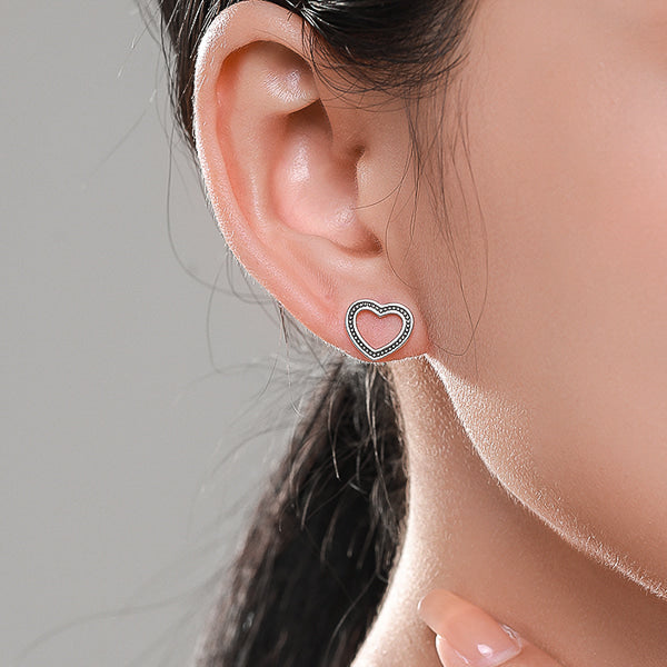 Woman wearing vintage heart stud earrings