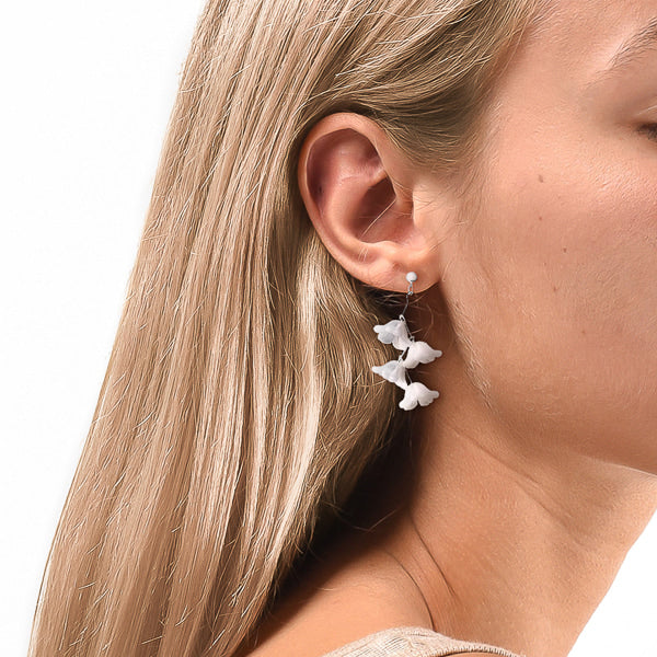 Woman wearing lily of the valley earrings